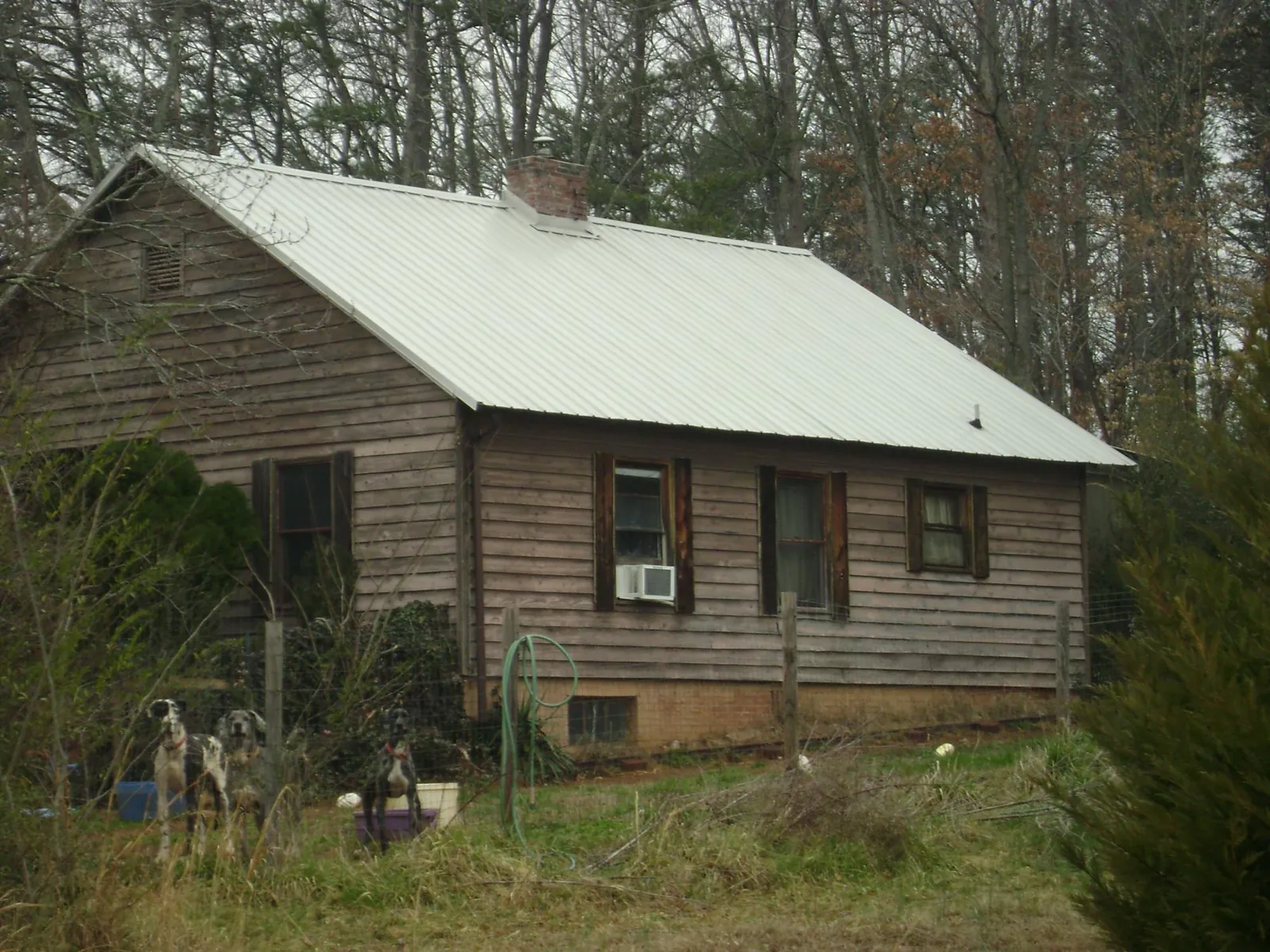 White metal roof on an old wood sided farmhouse, from a Metal Roof Installation job in Grovertown